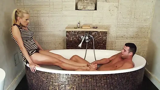 Stunning blonde gives a footjob in the bathroom