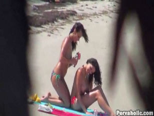 Two babes being spied on at the beach